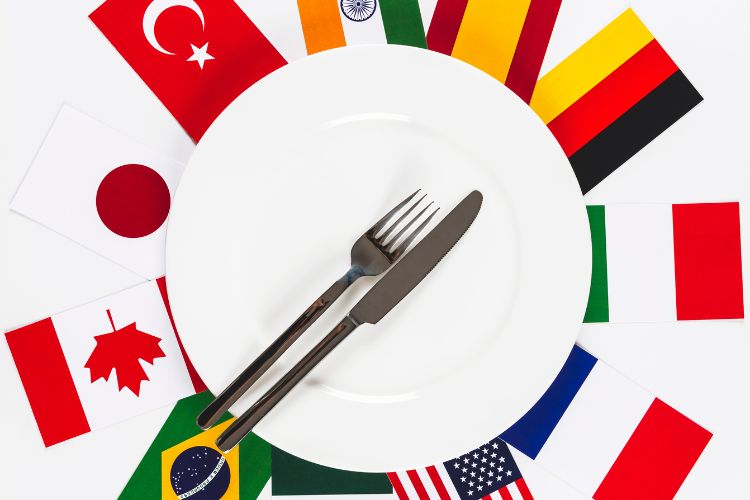 plate with kitchen utensils above the various country flags